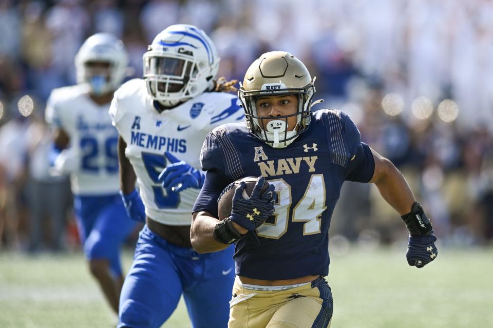 Sep 10, 2022; Annapolis, Maryland, USA;  Navy Midshipmen fullback Anton Hall Jr. (34) runs for a first half touchdown as Memphis Tigers linebacker Tyler Murray (5) chases at Navy-Marine Corps Memorial Stadium. Mandatory Credit: Tommy Gilligan-USA TODAY Sports