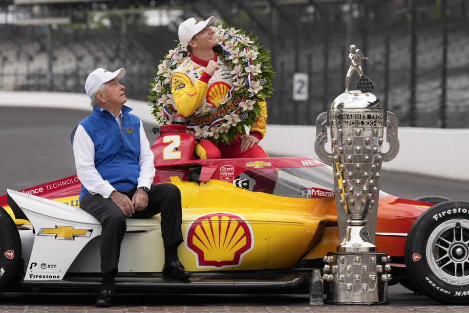 Roger Penske and Josef Newgarden pose with the Borg-Warner Trophy during the traditional winners photo session at Indianapolis Motor Speedway, Monday, May 27, 2024, in Indianapolis. Newgarden won the 108th running of the Indianapolis 500 auto race Sunday. (AP Photo/Darron Cummings)