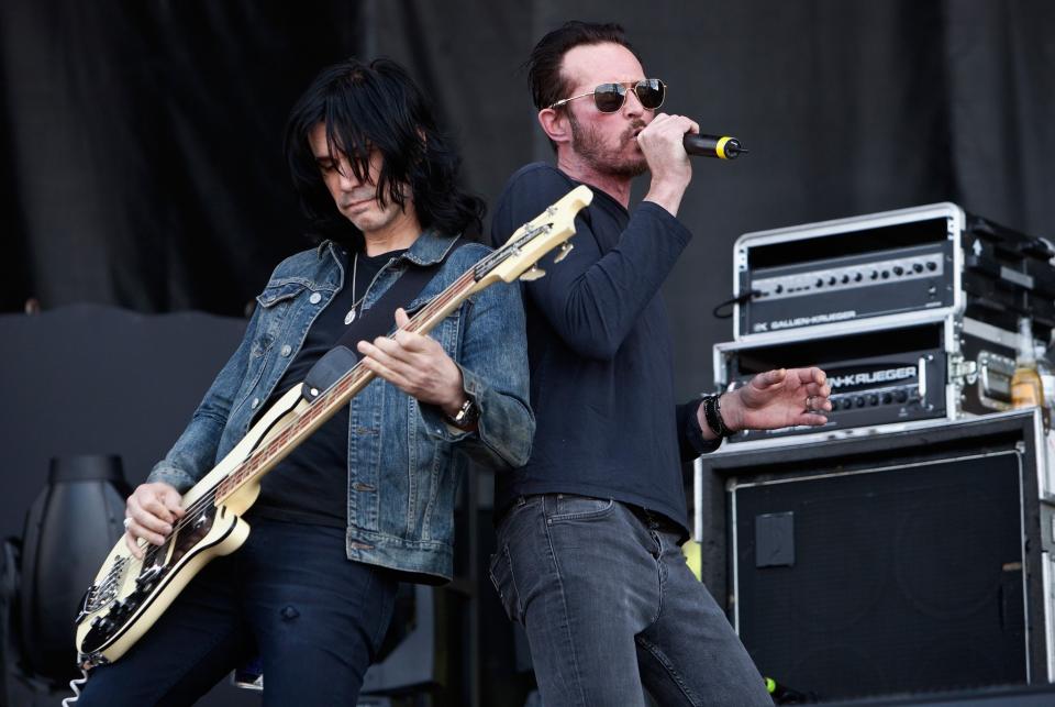 Bassist Tommy Black (left) and singer Scott Weiland of Scott Weiland and the Wildabouts perform during day 1 of the Carolina Rebellion at Charlotte Motor Speedway on May 2, 2015 in Charlotte, North Carolina. (Photo by Jeff Hahne/Getty Images)