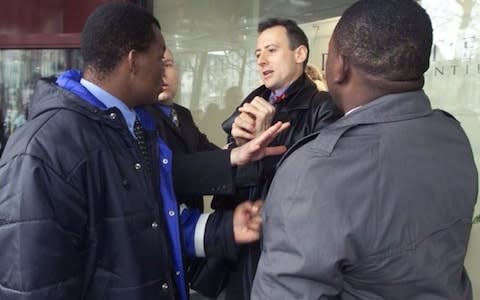 Peter Tatchell scuffles with Zimbabwean bodyguards while protesting against the visit of President Robert Mugabe to Brussels in March 2001 - Credit: Thierry Roge/REUTERS
