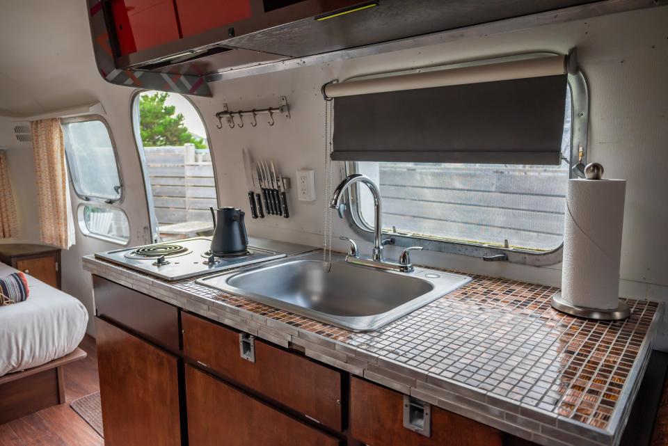 sink, teapot, small window in kitchen area of airstream