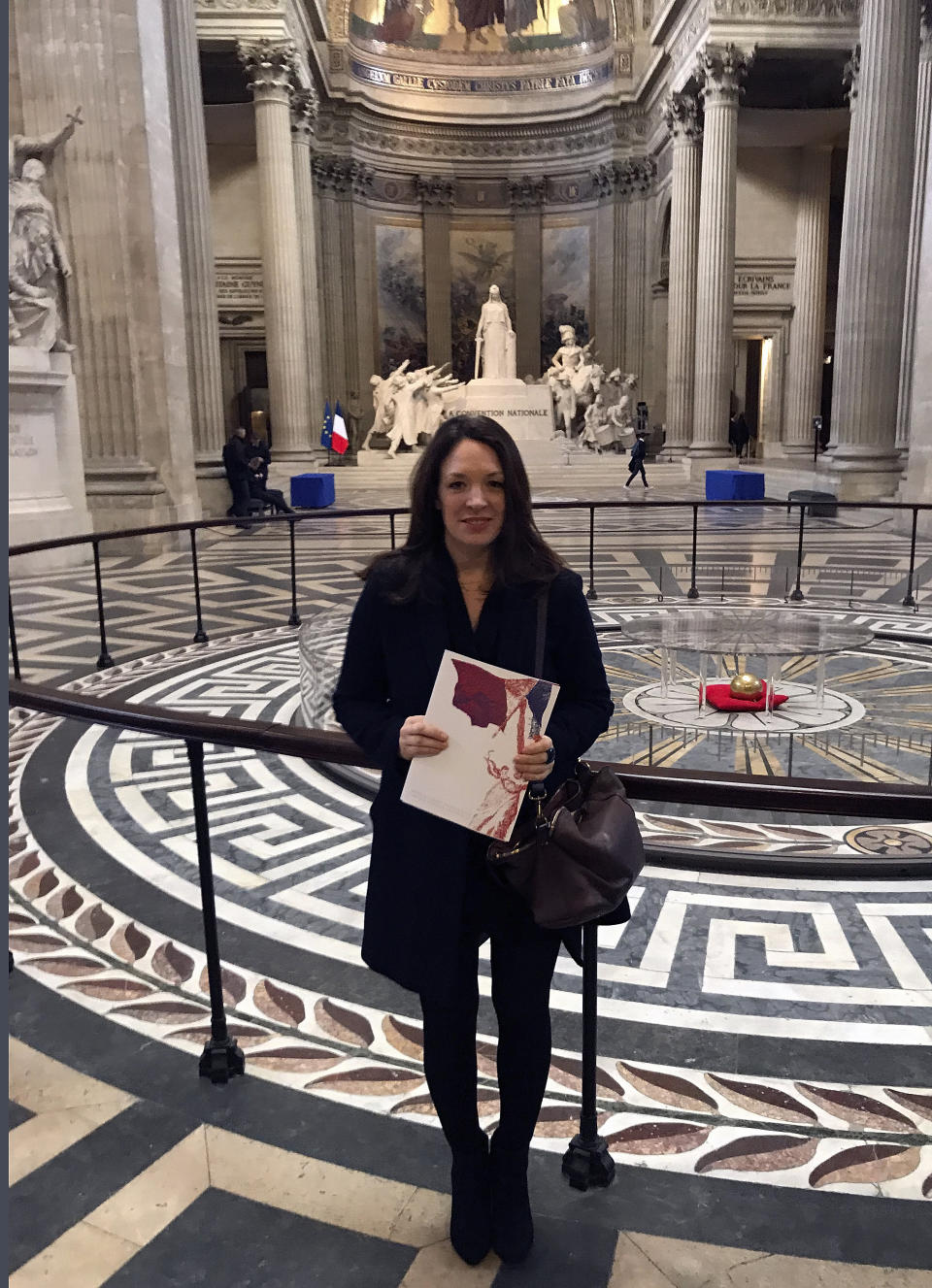 Britain's Catherine Norris Trent holds her document after a naturalization ceremony in Paris' Pantheon monument, Thursday, March 21, 2019. With the looming Brexit deadline, the 38-year-old mother of two who's lived in the French capital for over a decade was one of dozens of newly-minted French nationals attending the ceremony. (AP Photo/Thomas Admason)