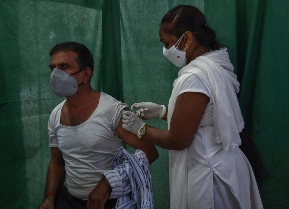 FILE - In this April 19, 2021, file photo, a health worker administers a vaccine for COVID-19 in Hyderabad, India. As deaths mount and a vaccine rollout falters badly, Prime Minister Narendra Modi has pushed much of the responsibility for fighting the outbreak onto unprepared and poorly equipped state governments. The crisis has badly dented Modi’s carefully cultivated image as an able technocrat. (AP Photo/Mahesh Kumar A., File)