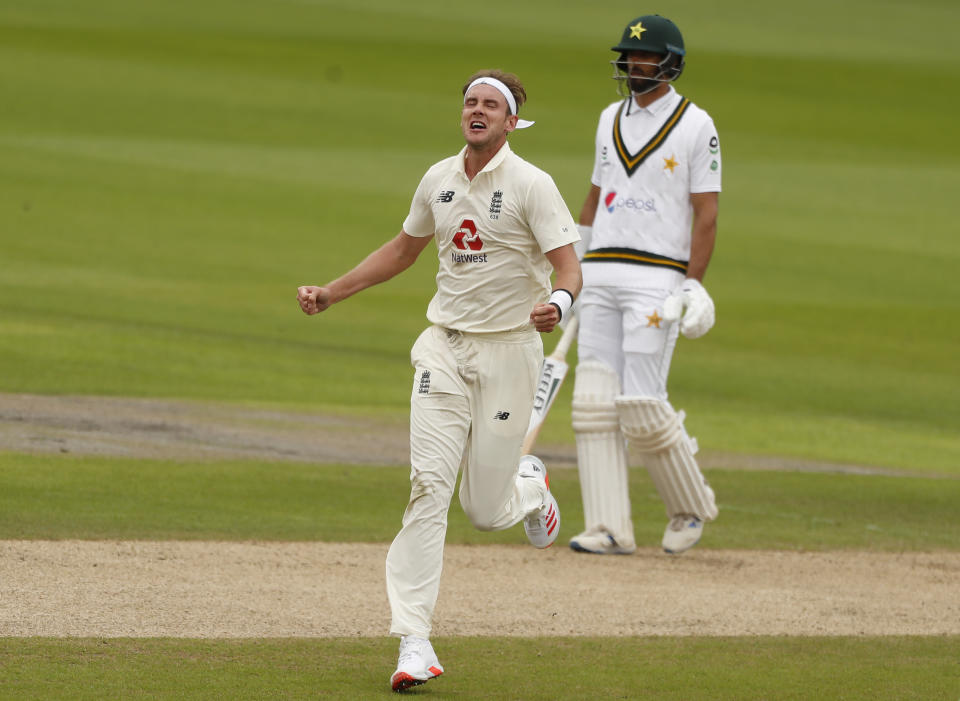 England's Stuart Broad, left, celebrates the dismissal of Pakistan's Asad Shafiq during the second day of the first cricket Test match between England and Pakistan at Old Trafford in Manchester, England, Thursday, Aug. 6, 2020. (Lee Smith/Pool via AP)