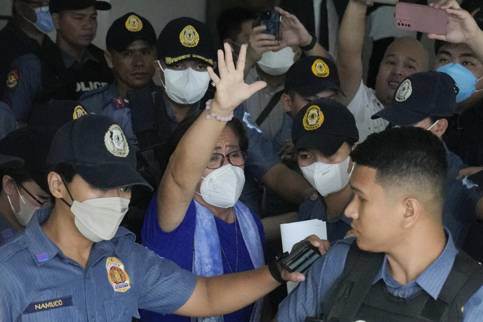 Detained former opposition Senator Leila de Lima, center, waves as she goes out of the Muntinlupa trial court on Friday, May 12, 2023 in Muntinlupa, Philippines. De Lima was acquitted by the Muntinlupa court in one of her drug related charges she says were fabricated by former President Rodrigo Duterte and his officials in an attempt to muzzle her criticism of his deadly crackdown on illegal drugs. (AP Photo/Aaron Favila)