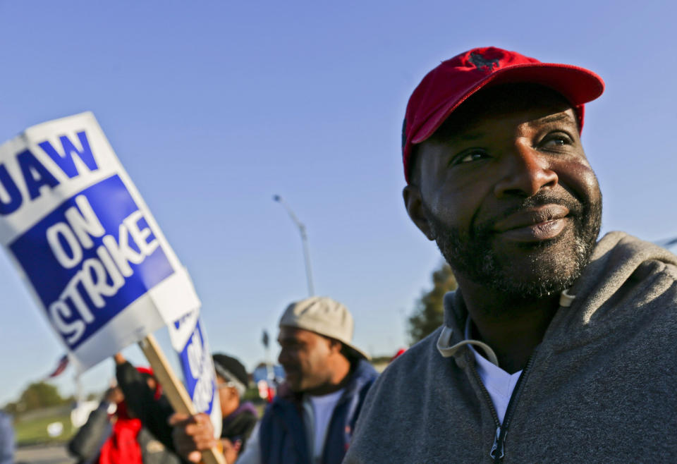 Temp Trim worker Darsuan Hall, of Florissant, looks towards oncoming traffic while standing on the picket line outside the General Motors plant in Wentzville, Mo., on Tuesday, Oct. 22, 2019. United Auto Workers around the country will be voting on whether to accept or reject the recent offer made to the union by GM in the coming week. (Troy Stolt/St. Louis Post-Dispatch via AP)