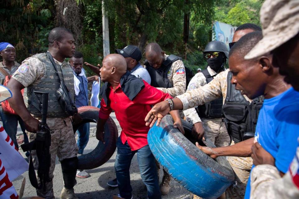 Police arrive to prevent demonstrators from burning tires during an anti-kidnapping protest in Port-au-Prince, Haiti, Thursday, Dec. 10, 2020. Port-au-Prince has seen an increase in gang violence and kidnappings while the government has proven to be incapable of controlling it.