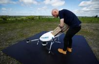 Drone operator from Manna Aero loads up essential household and medical supplies for delivery in Moneygall