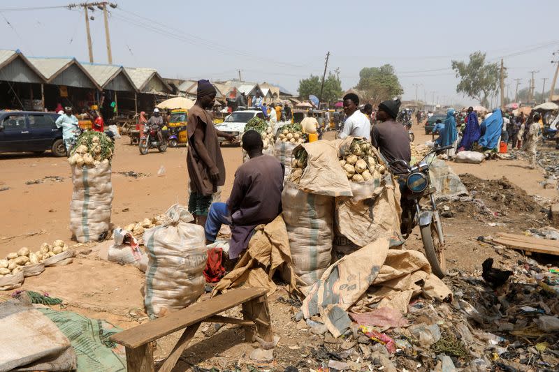 People stand in a market in Gusau