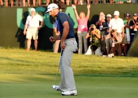 Jun 19, 2016; Oakmont, PA, USA; Dustin Johnson pumps his fist after making a birdie putt on the 18th green and winning the U.S. Open golf tournament at Oakmont Country Club. Mandatory Credit: John David Mercer-USA TODAY Sports