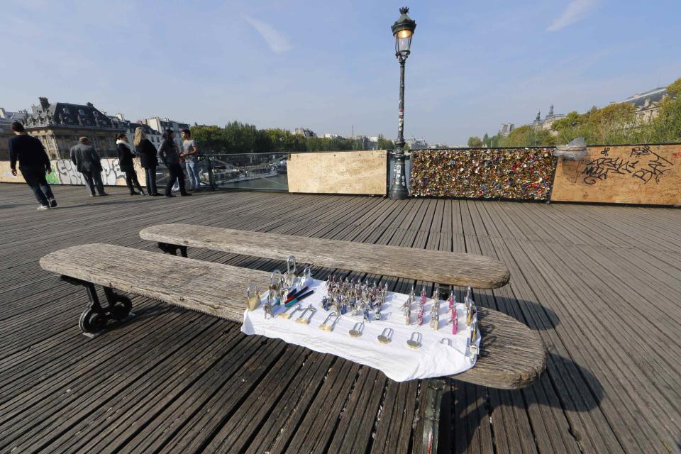 Padlocks are displayed on a bench for sale on the Pont des Arts over the River Seine in Paris September 23, 2014. (REUTERS/Jacky Naegelen)