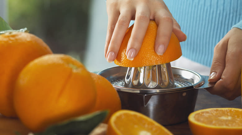 Woman juicing an orange