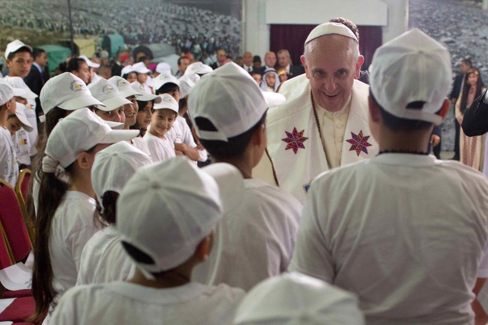 Pope Francis is greeted by children during a visit to the Dheisheh refugee camp on the outskirts of Bethlehem