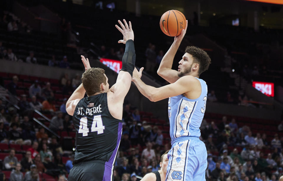 North Carolina forward Pete Nance, right, shoots over Portland center Joey St. Pierre during the first half of an NCAA college basketball game in the Phil Knight Invitational tournament in Portland, Ore., Thursday, Nov. 24, 2022. (AP Photo/Craig Mitchelldyer)