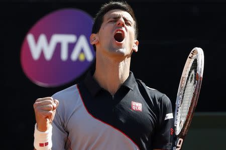 Novak Djokovic of Serbia reacts during his men's singles semi-final match against Milos Raonic of Canada at the Rome Masters tennis tournament May 17, 2014. REUTERS/Stefano Rellandini