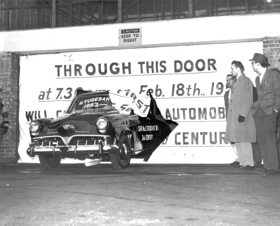 In this Feb. 18, 1952, file photo, a Studebaker Champion drives through a sign celebrating the centennial of the Studebaker Corp. and the start of its next 100 years. On the driver's side panel, it says, "Car No. 1 Studebaker's 2nd century." On Dec. 9, 1963, the company announced it would cease production in South Bend and shift its operations to its plant in Hamilton, Ont., which later closed in 1966.