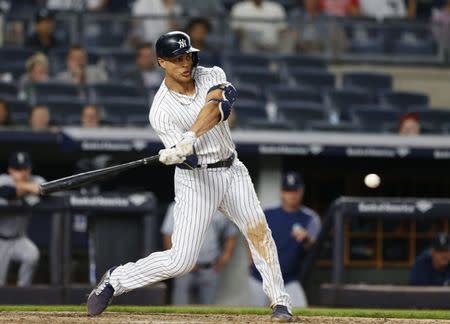 Jun 20, 2018; Bronx, NY, USA; New York Yankees left fielder Giancarlo Stanton (27) hits a walk off home run against the Seattle Mariners at Yankee Stadium. Mandatory Credit: Noah K. Murray-USA TODAY Sports