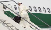 Pope Francis boards a plane for his pastoral trip, at Fiumicino airport in Rome, Italy, July 5, 2015. REUTERS/Max Rossi/File Photo