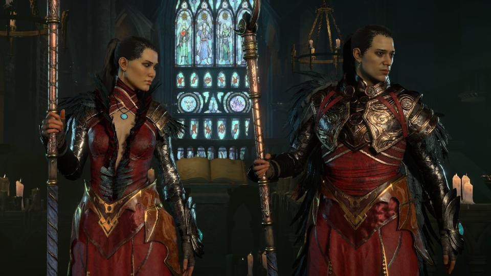 two sorcerers standing next to each other wearing matching red and gold armor