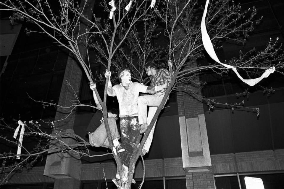 UNC fans celebrate from atop a tree on Franklin Street in Chapel Hill, NC after UNC’s National Championship win over Georgetown in 1982.