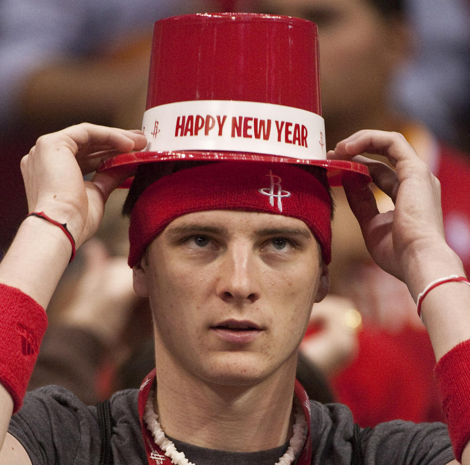 Houston Rockets fan Justin Keller adjusts his New Year's party hat before a Dec. 31, 2011, game against the Atlanta Hawks. (AP/Dave Einsel)