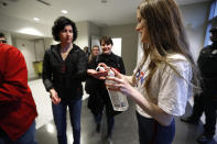 Volunteers supply hand sanitizer before to the public as they enter a campaign rally at Renaissance High School for Democratic presidential candidate former Vice President Joe Biden in Detroit, Monday, March 9, 2020. (AP Photo/Paul Sancya)