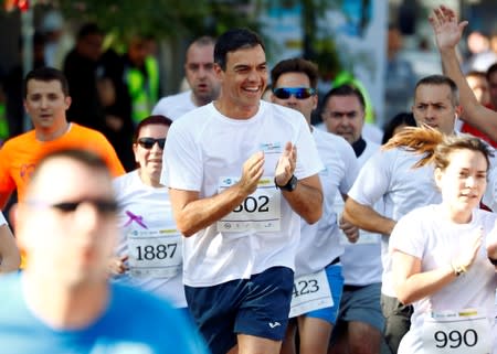 FILE PHOTO: Spain's acting Prime Minister Pedro Sanchez takes part in a running race against gender-based violence in Madrid