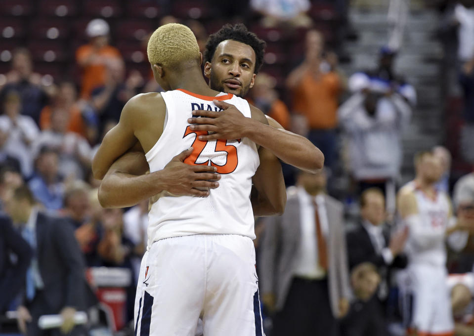 Virginia's Mamadi Diakite (25) hugs Braxton Key after Virginia defeated Oklahoma 63-51 in a second-round men's college basketball game in the NCAA Tournament in Columbia, S.C., Sunday, March 24, 2019. (AP Photo/Richard Shiro)