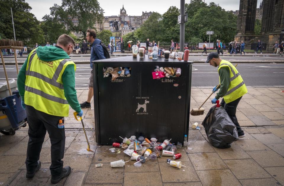 Staff from Essential Edinburgh collect some of the litter from around the bins along Princes Street in Edinburgh (Jane Barlow/PA) (PA Wire)