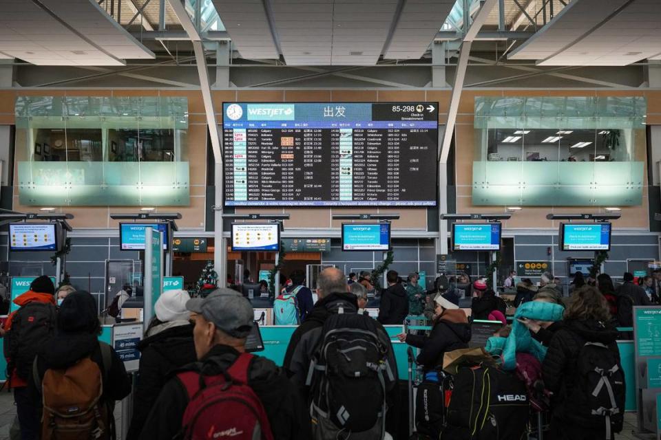 Passengers wait in a check-in line at Vancouver International Airport. A Charlotte to Vancouver flight from American Airlines that begins in June will be the only nonstop service between North Carolina and British Columbia.
