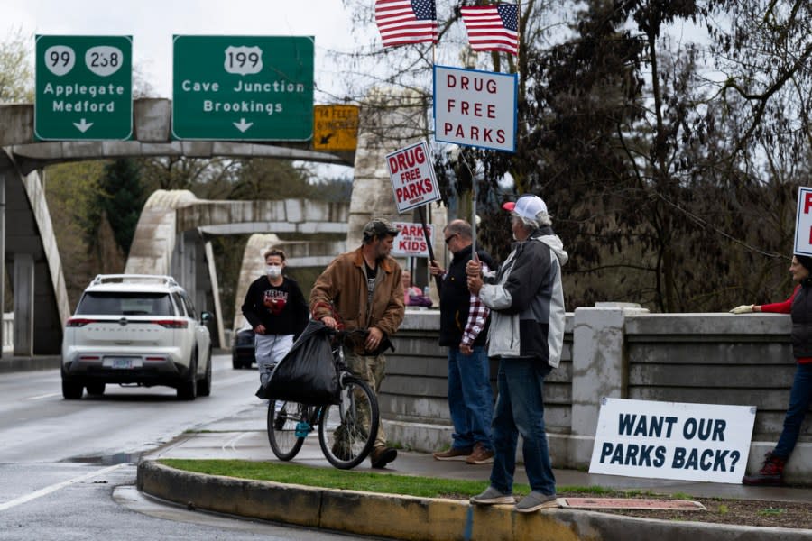 Members of the self-proclaimed "park watch" group protest on Friday, March 22, 2024, in Grants Pass, Ore. (AP Photo/Jenny Kane)