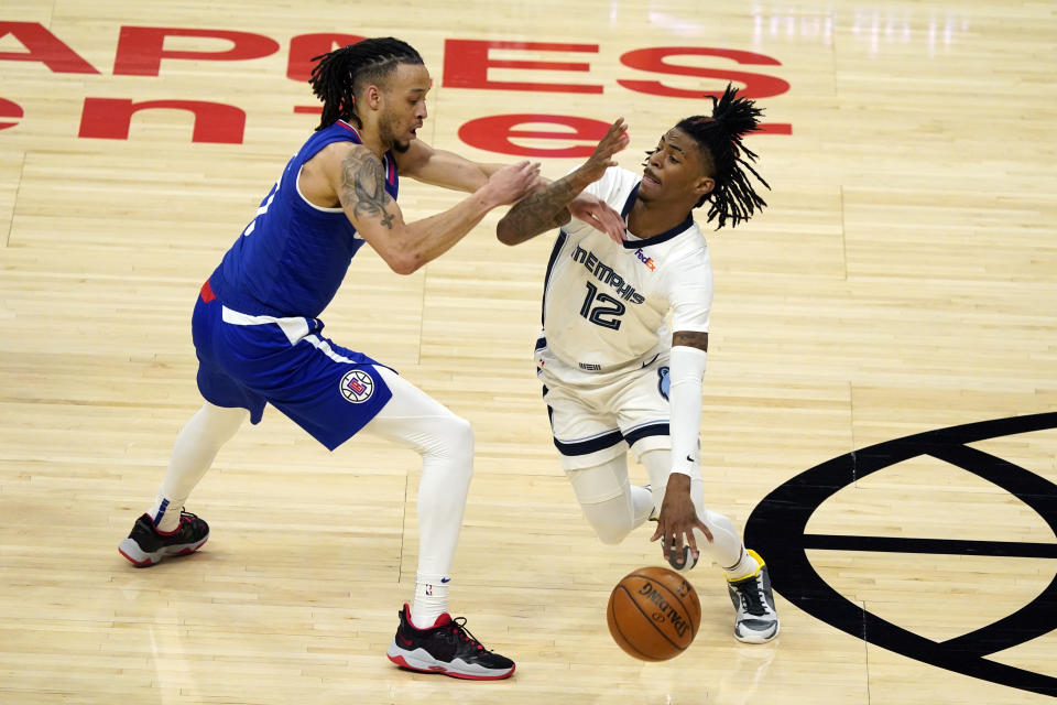 Memphis Grizzlies guard Ja Morant (12) is defended by Los Angeles Clippers guard Amir Coffey during the first half of an NBA basketball game Wednesday, April 21, 2021, in Los Angeles. (AP Photo/Marcio Jose Sanchez)