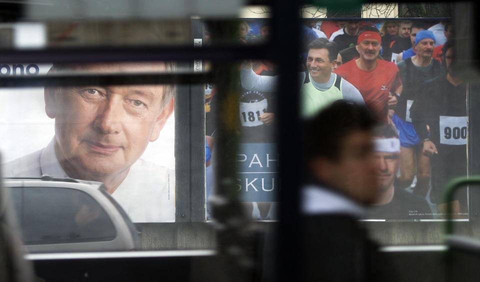 Electoral posters of president incumbent, Danilo Turk, left and former prime minister Borut Pahor are seen through a bus window in Ljubljana, Slovenia, Friday, Nov. 30, 2012. Runoff for presidential elections will be held on Sunday, Dec. 2, 2012. (AP Photo/Matej Leskovsek)