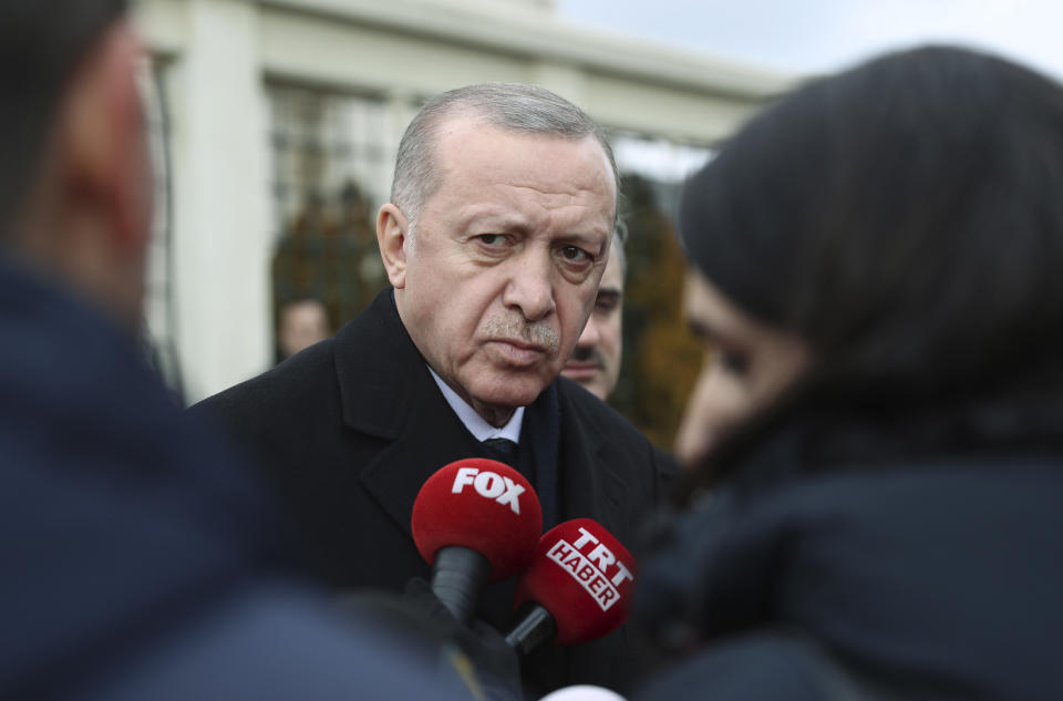 Turkish President Recep Tayyip Erdogan speaks to the media after Friday prayers, in Istanbul, Friday, Feb. 21. Erdogan held telephone calls with French and German leaders Friday during which he called for an end to a Syrian government offensive on the last rebel stronghold in the country that has displaced hundreds of thousands of people. (Presidential Press Service via AP, Pool)