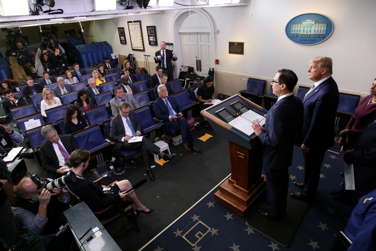 U.S. President Donald Trump looks on as Treasury Secretary Steven Mnuchin addresses the daily coronavirus (COVID-19) briefing at the White House in Washington, U.S., March 17, 2020. REUTERS/Jonathan Ernst