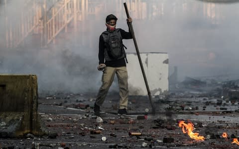 Protesters clash with police in Tanah Abang wholesale market in Jakarta - Credit: Getty