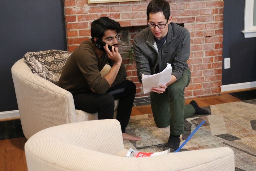 Director Phillip Anjum talks screenplay notes with Taha Mandviwala, who plays Asad, behind the scenes during the shooting of "A Place For Us."