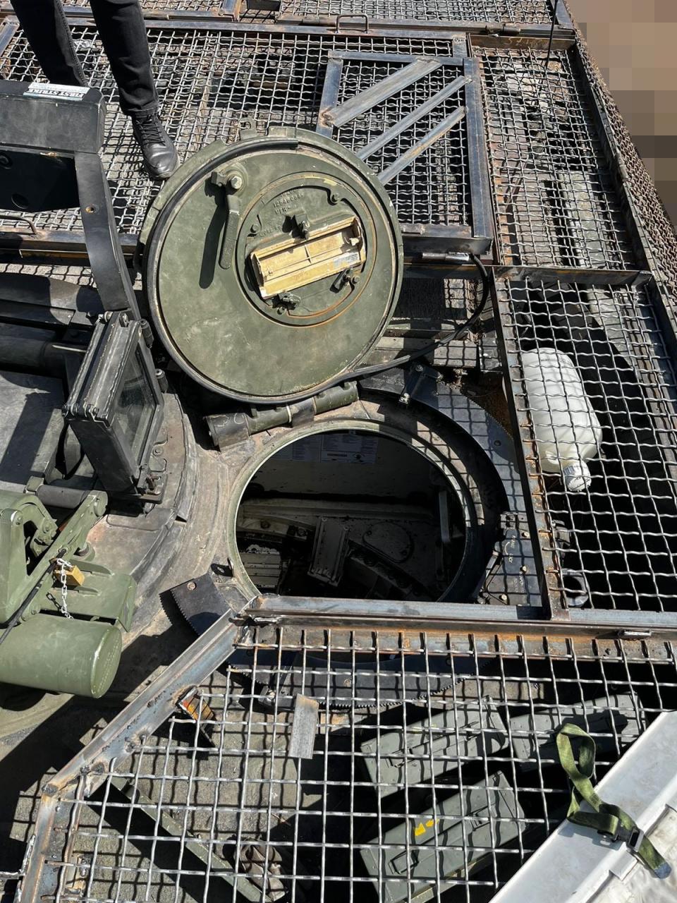 A top-down look at the gunner hatch and the panel above that folds over it when it is closed. A portion of the additional protection fitted around the commander's hatch is visible to the left. What may be other hinged sections over the blowout panels can be seen at the top of this picture. <em>Metinvest</em>