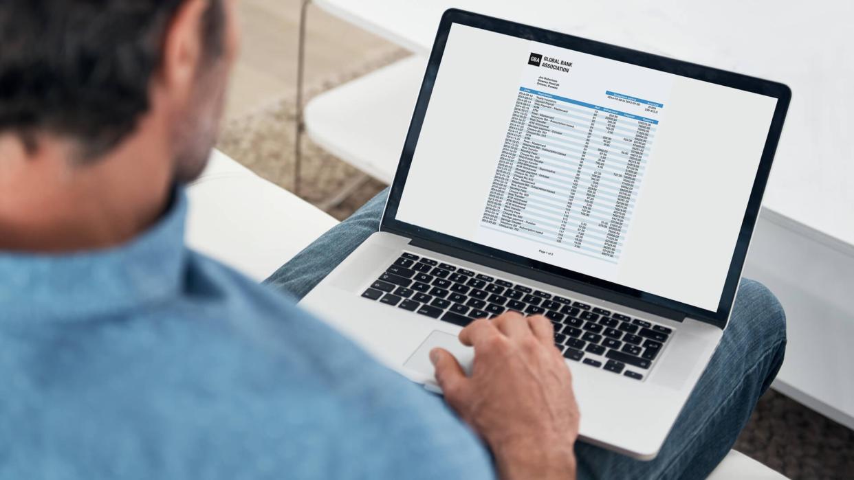 Cropped shot of a man working on his laptop at homehttp://195.