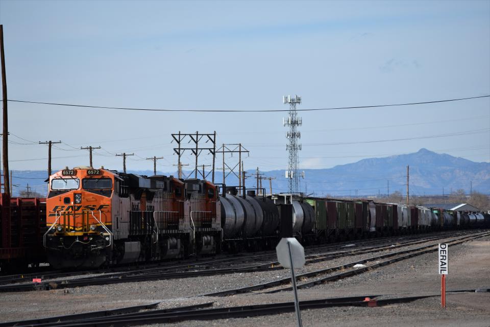 A BNSF Railway train sits on the tracks near the Midtown Shopping Center on Monday, Dec. 5, 2022.