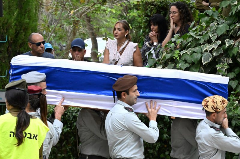 Israeli soldiers carry the flag draped coffin of Col. Roi Levy, commander of the elite 'Ghost' multi-dimensional unit, at his funeral in the Mt. Herzl Military Cemetery in Jerusalem, on Monday. Levy was born in America and grew up in Jerusalem and was killed in a battle with Hamas terrorists in Kibbutz Re'im on the Gaza border. Photo by Debbie Hill/ UPI