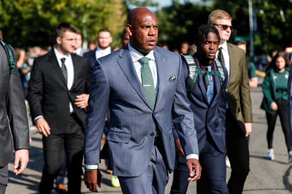 Michigan State head coach Mel Tucker and players march towards Spartan Stadium before the Youngstown State game in East Lansing on Saturday, Sept. 11, 2021.