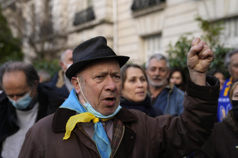 A main raises his fist as he marches in support of Ukraine during a demonstration in front of the Russian embassy in Paris, France, Tuesday, Feb. 22, 2022. World leaders are getting over the shock of Russian President Vladimir Putin ordering his forces into separatist regions of Ukraine and they are focusing on producing as forceful a reaction as possible. Germany made the first big move Tuesday and took steps to halt the process of certifying the Nord Stream 2 gas pipeline from Russia. (AP Photo/Francois Mori)