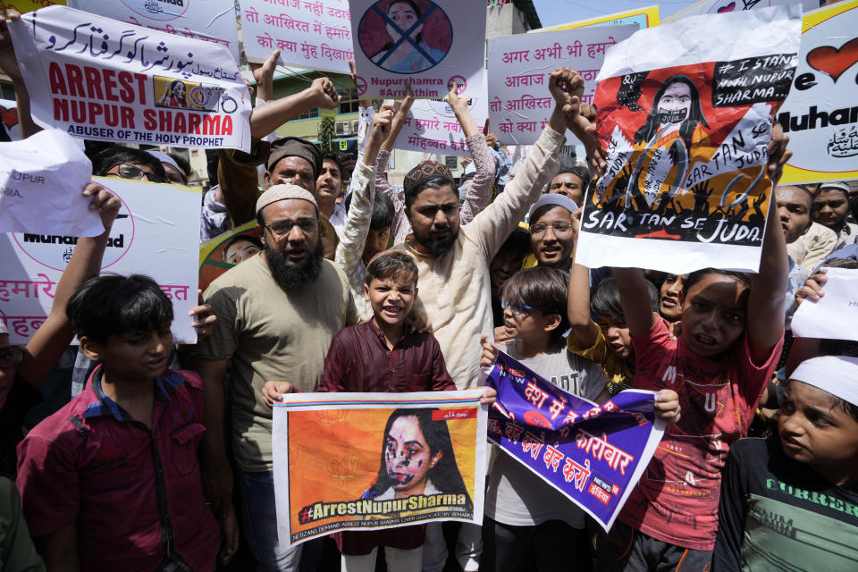 Indian Muslims hold placards demanding the arrest of Nupur Sharma, a spokesperson of governing Hindu nationalist party as they react to the derogatory references to Islam and the Prophet Muhammad made by her during a protest in Ahmedabad, India, Friday, June 10, 2022. At least five Arab nations have lodged official protests against India, and Pakistan and Afghanistan also reacted strongly Monday to the comments made by two prominent spokespeople from Prime Minister Narendra Modi's Bharatiya Janata Party. (AP Photo/Ajit Solanki)