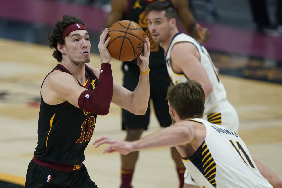 Cleveland Cavaliers' Cedi Osman (16) drives to the basket against Indiana Pacers' Domantas Sabonis (11) during the first half of an NBA basketball game Wednesday, March 3, 2021, in Cleveland. (AP Photo/Tony Dejak)