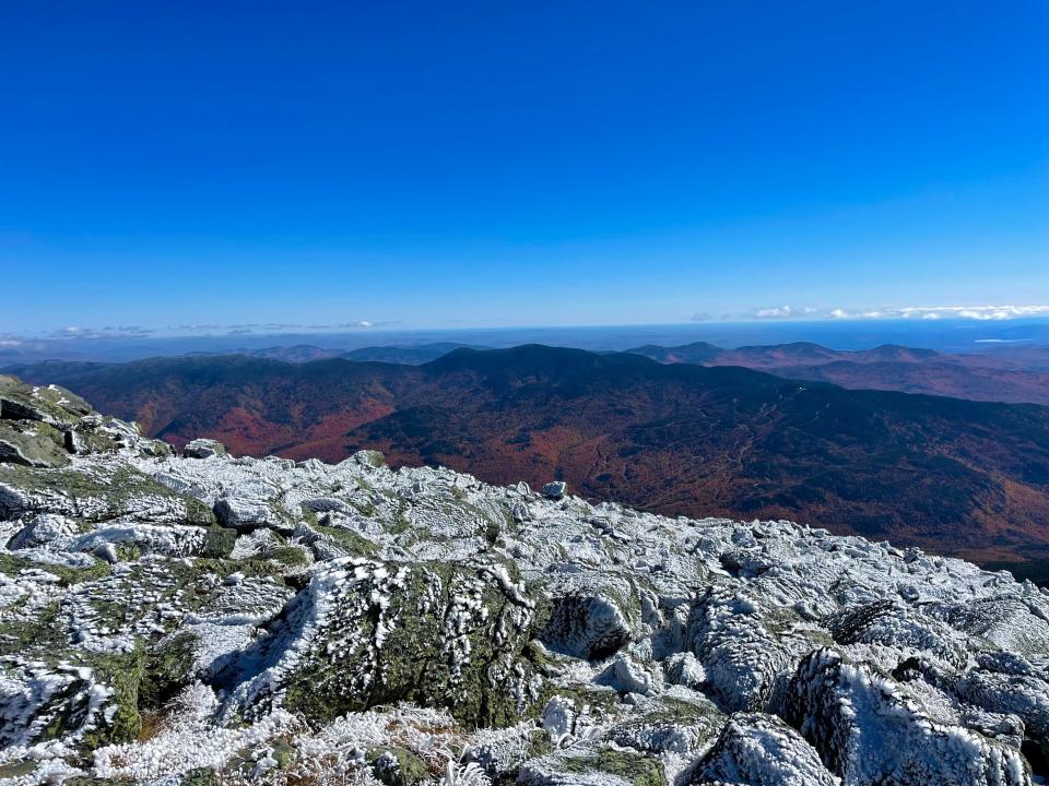 View of fall valley from the summit of an icy mountain