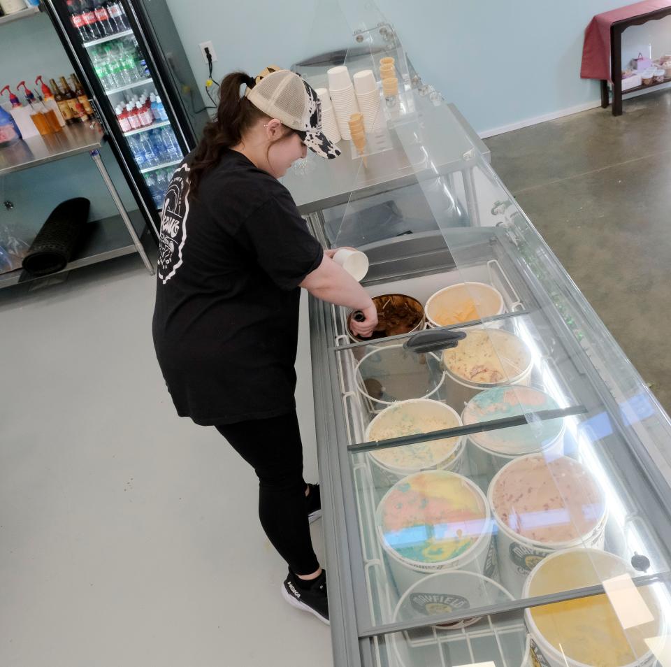 Brittany Powers dips ice cream on March 14, 2023, at Liza's Sweet Shop at The Venue, a collection of restaurants, a bar, and entertainment venue on Watermelon Road in Tuscaloosa.