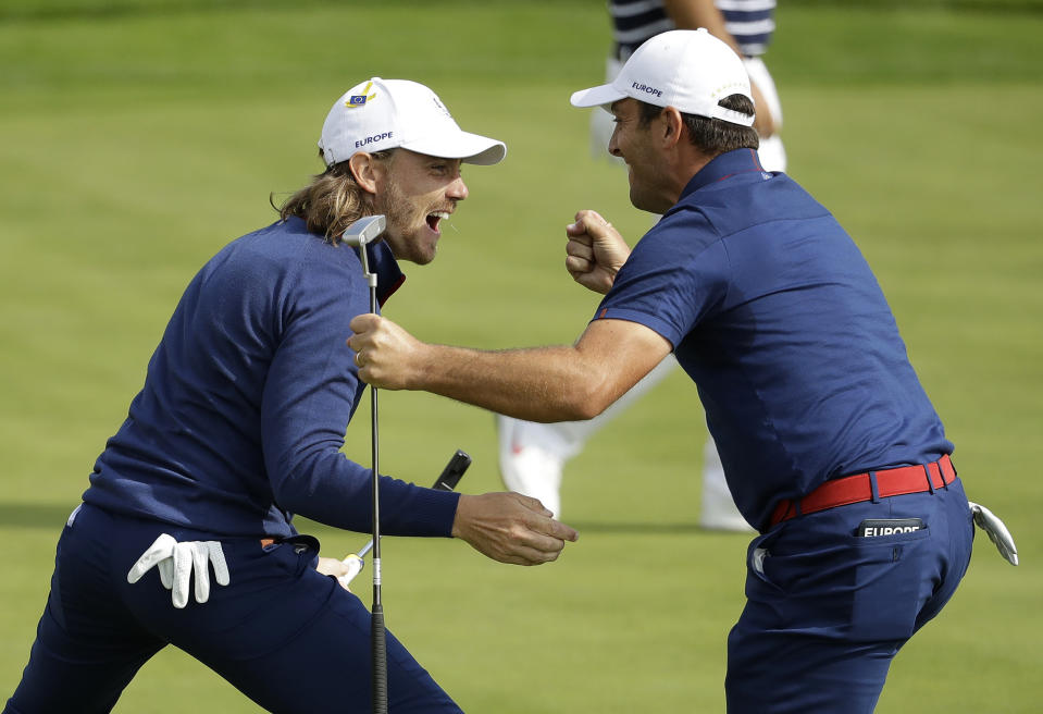 Europe's Francesco Molinari, right, and Europe's Tommy Fleetwood winning a hole in their fourball match on the opening day of the 42nd Ryder Cup at Le Golf National in Saint-Quentin-en-Yvelines, outside Paris, France, Friday, Sept. 28, 2018. (AP Photo/Matt Dunham)