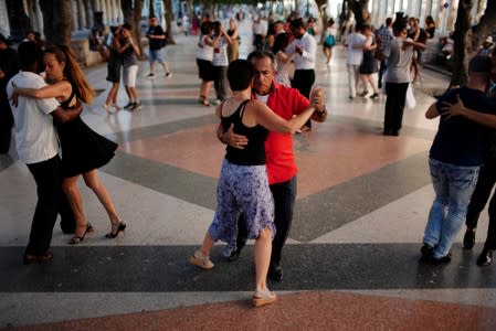 People dance tango during a weekly Sunday milonga on Havana's Paseo del Prado promenade
