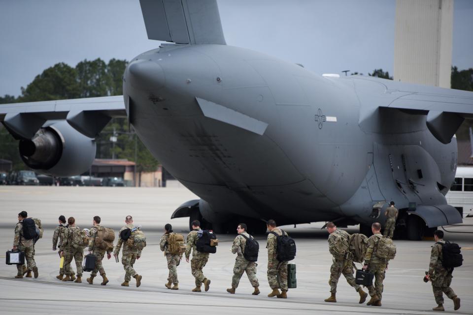 Soldiers with the 82nd Airborne Division head out to board a C-17 cargo plane at Pope Army Airfield for a deployment to Eastern Europe on Feb. 3, 2022.